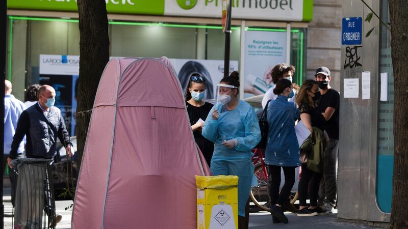 A medic stands beside a pop-up tent set up on a street for Covid-19 testing in the 18th arrondissement in Paris. Photograph: Nathan Laine/Bloomberg