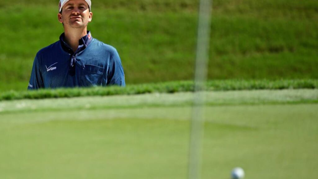 Graeme McDowell watches his shot from a bunker on the third green during a practice round for The Players championship at TPC Sawgrass in Ponte Vedra Beach, Florida. Photograph: John Rouxa/PA