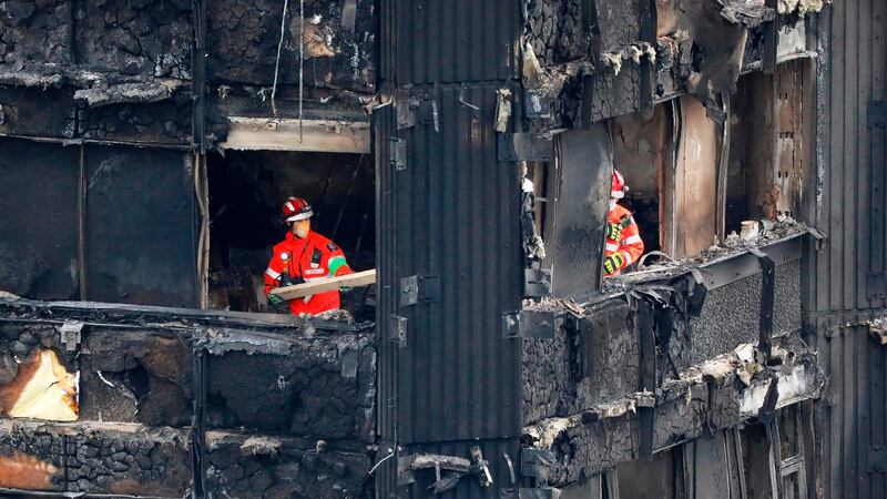 Combustible cladding: members of the emergency services work on the remains of Grenfell Tower. Photograph: Tolga Akmen/AFP/Getty