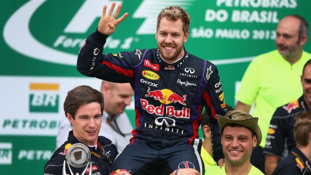 Race winner Sebastian Vettel  celebrates on the podium with Red Bull team-mates following the Brazilian Formula One Grand Prix  in Sao Paulo. Photograph:  Clive Mason/Getty Images