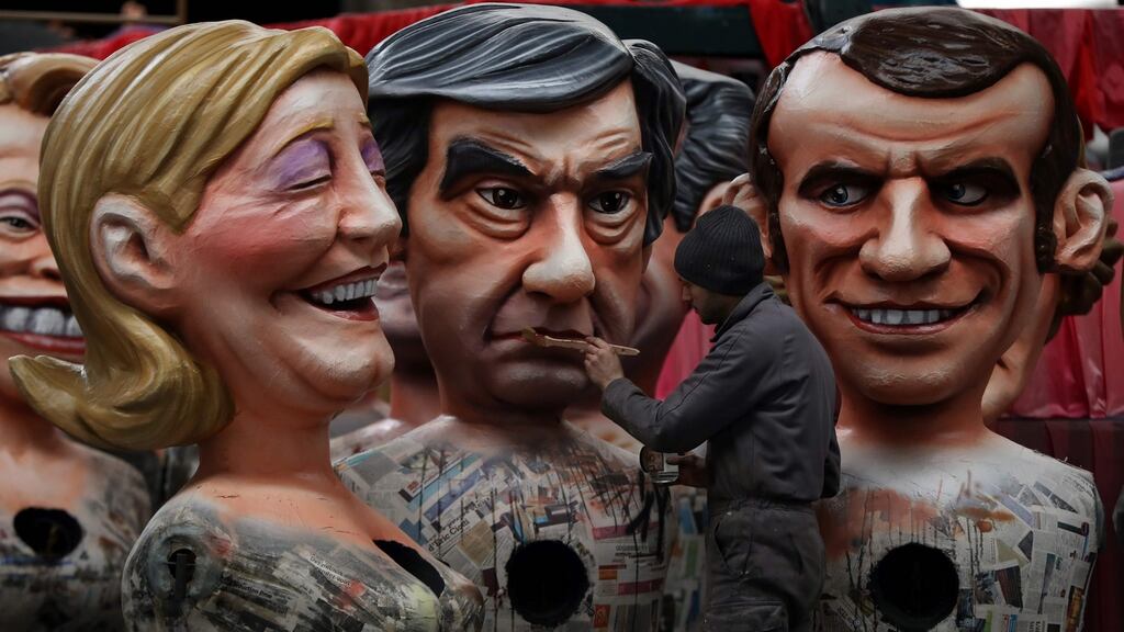A man works with figures of presidential candidates Marine Le Pen, Francois Fillon and Emmanuel Macron in Nice, southeastern France, during the preparation of the 133rd Nice Carnival. Photograph: Valery Hache/AFP/Getty Images