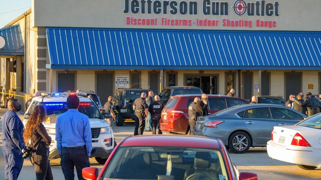 Bystanders react at the scene of a multiple fatality shooting at the Jefferson Gun Outlet. Photograph: Matthew Hinton/AP Photo