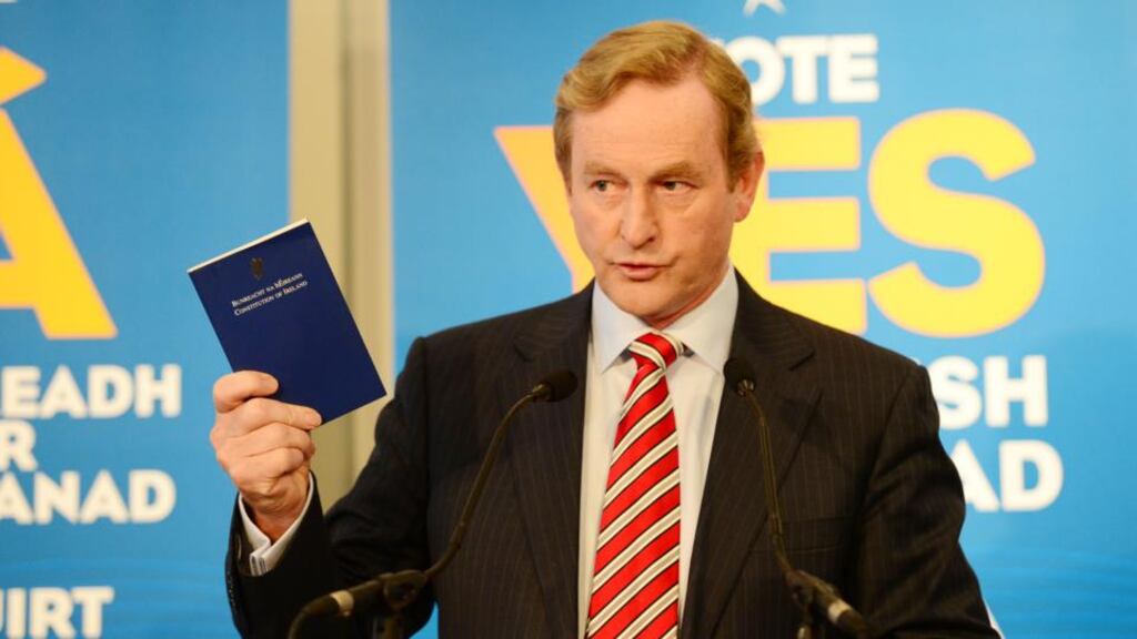 Taoiseach Enda Kenny TD holds a copy of Bunreacht na hEireann at the RHA Dublin today where he officially launched Fine Gael’s campaign for a Yes vote in the forthcoming referendum. Photograph: Bryan O’Brien / The Irish Times