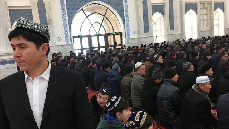 Men pray at the mosque at the Xinjiang Islamic Institute during a government organised trip in Urumqi, Xinjiang, China. Photograph: Ben Blanchard/Reuters