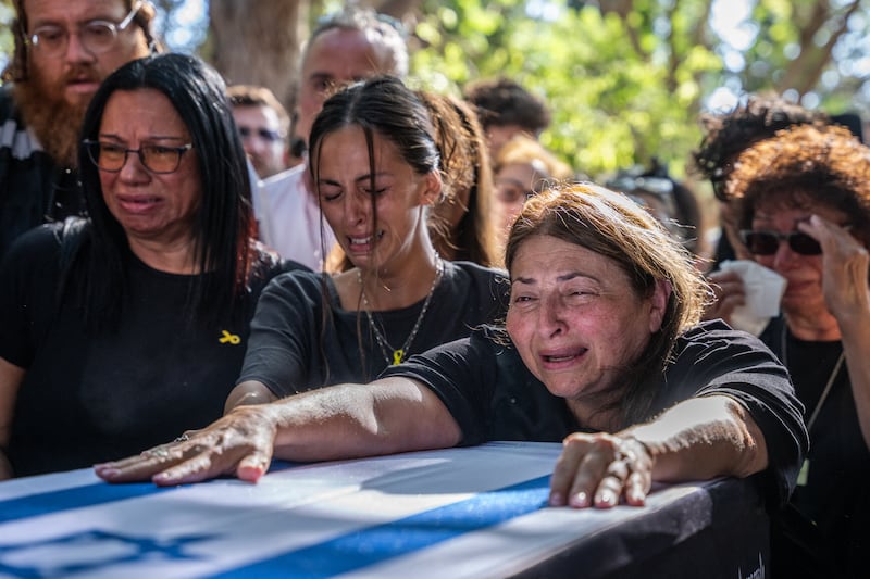 The mother of Israeli hostage Idan Shtivi and relatives react by his coffin during a funeral in Kfar Maas, in central Israel, on Monday, days after the remains of two hostages were recovered from Gaza in a military operation. Photograph: Maya Levin/AFP via Getty Images