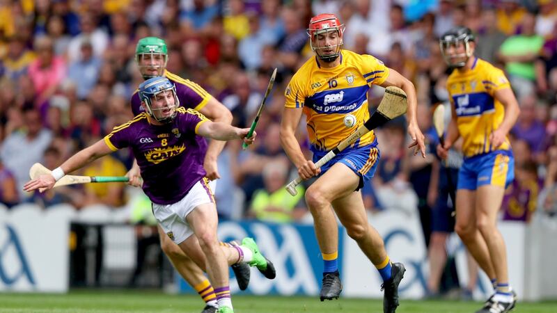 Clare’s Peter Duggan carries against Wexford with Kevin Foley in pursuit. Photograph: Oisin Keniry/Inpho