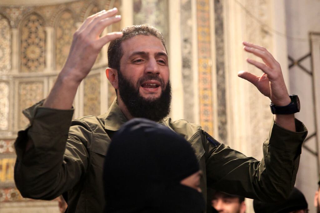 The leader of Syria's Islamist Hayat Tahrir al-Sham group, Abu Mohammed al-Jolani, addresses a crowd at the capital's landmark Umayyad Mosque. Photograph: Aref Tammawi/AFP via Getty Images