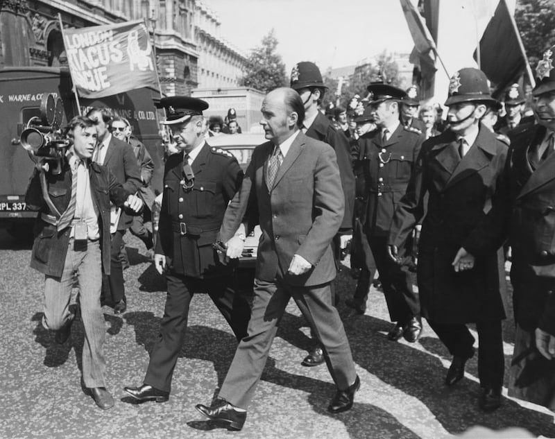 Patrick Hillery is escorted by police to his car in London in 1971. Photograph: Central Press/Hulton Archive/Getty