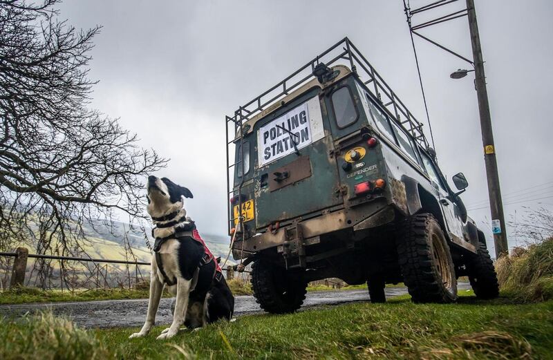 A dog next to a polling station sign in Low Row, Yorkshire, England. Photograph: Danny Lawson/PA Wire