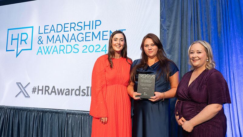 Adam Coleman, founder and chief executive, HRLocker, presents the HR team of the year (small - under 250+ employees) award to Chantel Smith, MDE Installations