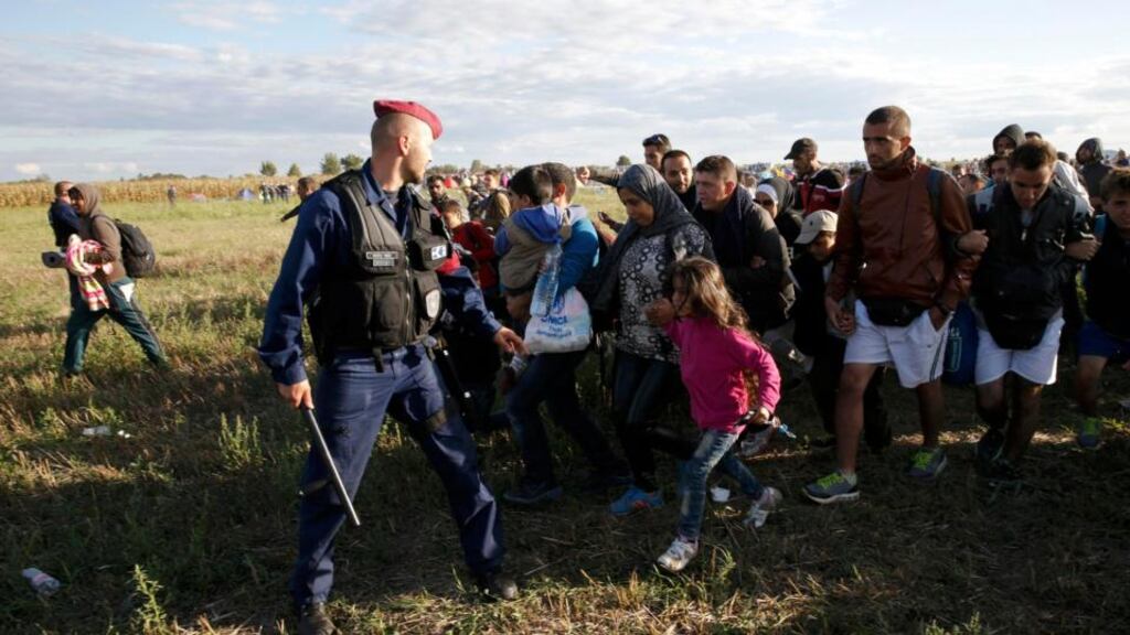 A group of migrants leaves a collection point in the village of Roszke, Hungary. Photograph: Marko Djurica/Reuters