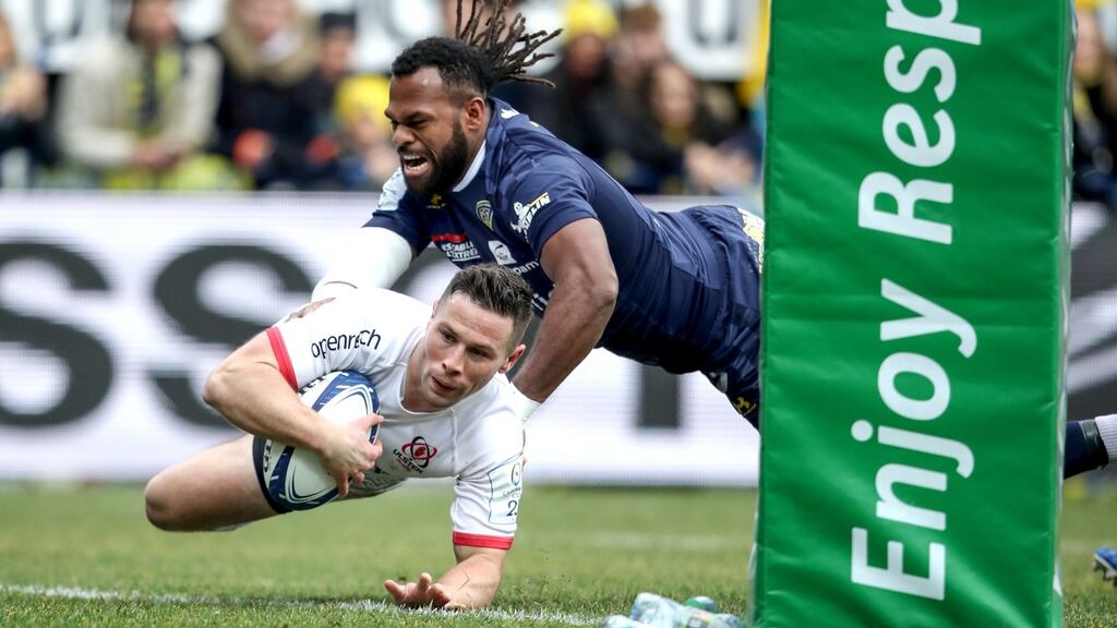Ulster scrumhalf John Cooney gets over for a try despite the attempts of Alivereti Raka of Clermont Auvergne during the Heineken Champions Cup match at Stade Marcel-Michelin. Photograph: Dan Sheridan/Inpho