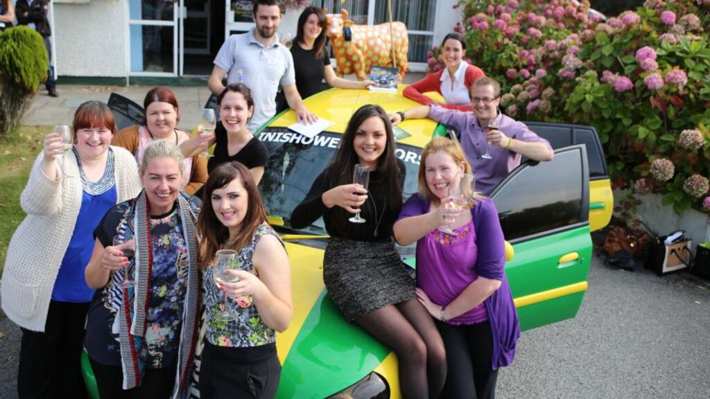 Maria Doherty (seated on car) with Forward Emphasis syndicate members who were winners of the midweek Lotto. Photograph: North West Newspix