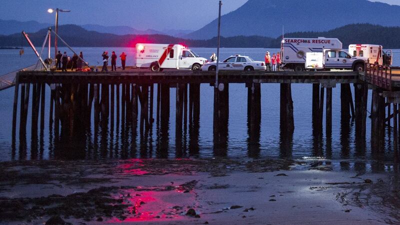 Rescue personnel mounting a search for victims of a capsized whale-watching boat park on a wharf in Tofino, British Columbia. Photograph: Adam Chilton/Reuters