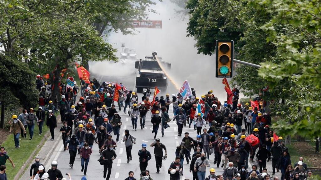 Turkish protestors clash with riot police in Istanbul, Turkey. Police used water cannon and tear gas to disperse protestors during a rally for May day. Photograph: Tolga Bozoglu/EPA