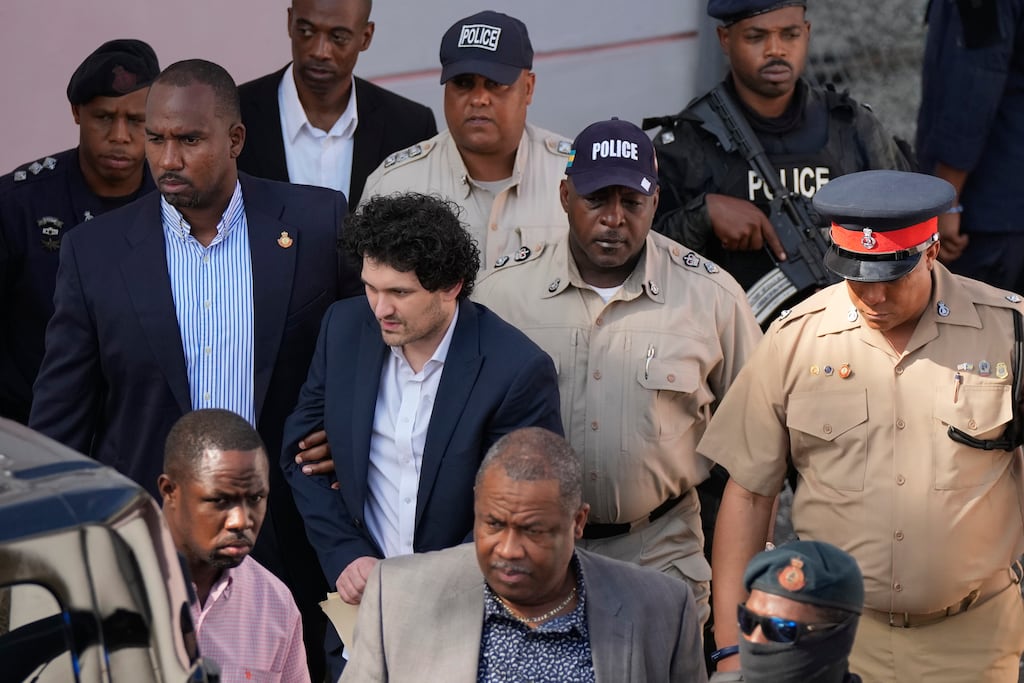 FTX founder Sam Bankman-Fried is escorted out of court in the Bahamas. Photograph: Rebecca Blackwell/AP/PA