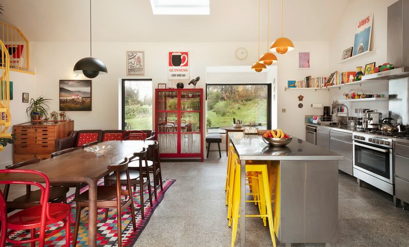 A curved Italian stainless steel kitchen was beyond their means but inspired an internet search that introduced them to Stainless Steel Solutions in Co Kilkenny. It includes an island with banana yellow Tolix barstools and a mid-century dining table and chairs