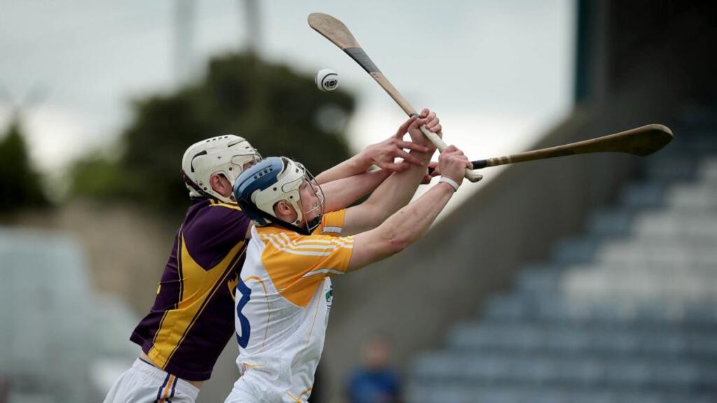 Antrim’s Conor Johnson battles for possession with Liam Ryan of Wexford in Portlaoise. Photograph: Morgan Treacy/Inpho