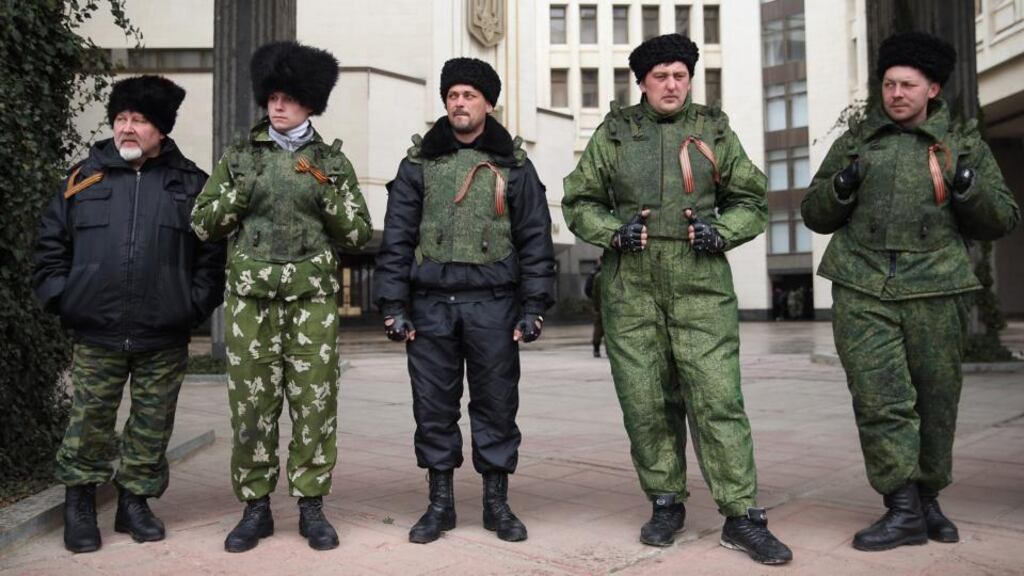 Cossacks stand guard at the entrance to the Crimean Parliament building  in Simferopol, Ukraine.