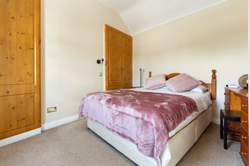 The main bedroom is to the front of the property, up a few steps, with two built-in wardrobes. Photograph: Keith Owens