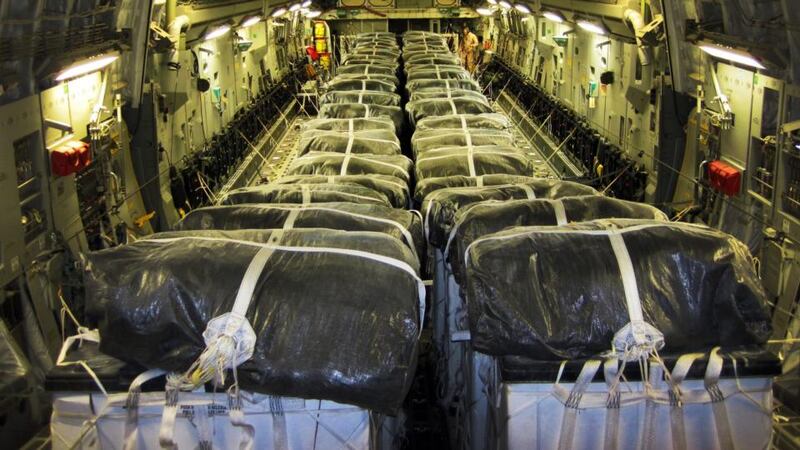 A handout picture made available by the US department of defense today shows pallets of bottled water being loaded aboard a US Air Force C-17 Globemaster III aircraft in preparation for a humanitarian airdrop over Iraq.