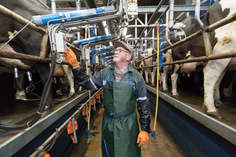 Roger Fahy in the milking parlour on the farm near new Quay, Co Clare. Photograph: Eamon Ward