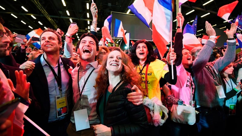 Supporters of Emmanuel Macron, French presidential election candidate for the En Marche! movement, celebrate after the results of the first round of the presidential election, at the Parc des Expositions in Paris. Photograph: Eric Feferberg/AFP/Getty Images