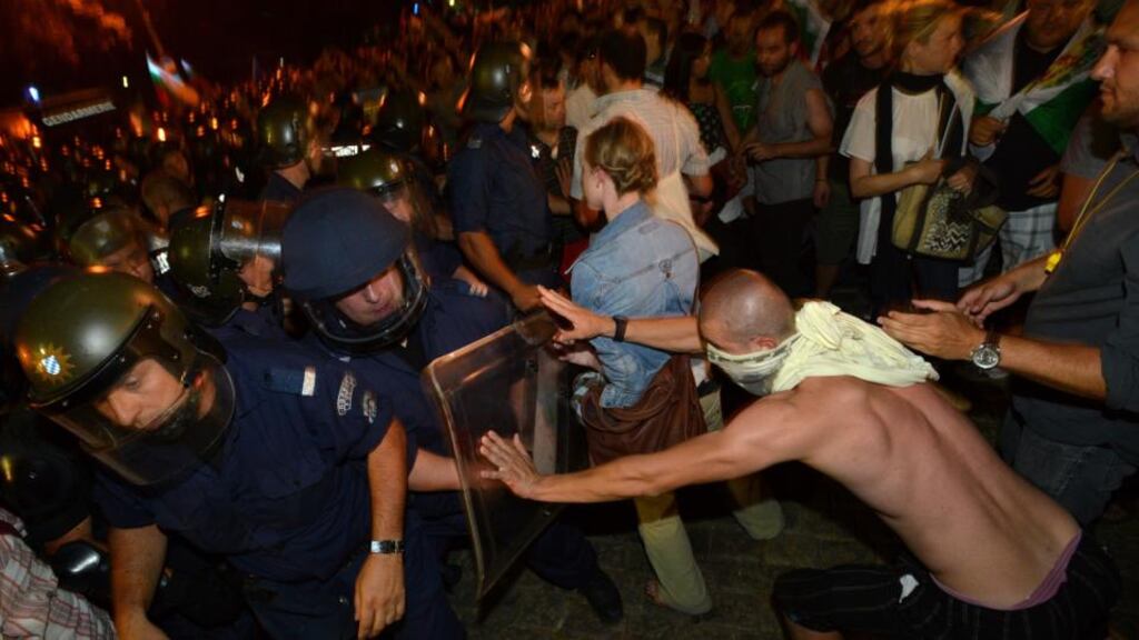 Protesters clash with Bulgarian riot police during an anti-government protest in front of the parliament building in Sofia. Photograph: AP Photo/Georgi Kozhuharov