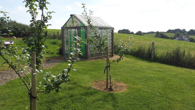 The greenhouse made from plastic bottles in Glaslough, Co Monaghan, as part of its Tidy Towns project. It is powered by a windmill made from discarded aluminium cans