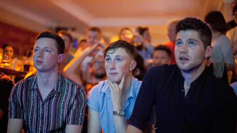 Left to right:  Thomas Sammon from Letterkenny Co Donegal; Aaron Murray from Longwood, Co Meath; and Jack Cody from Dublin watch the Conor McGregor vs Floyd Mayweather match in a Dublin city pub. Photograph: Tom Honan.