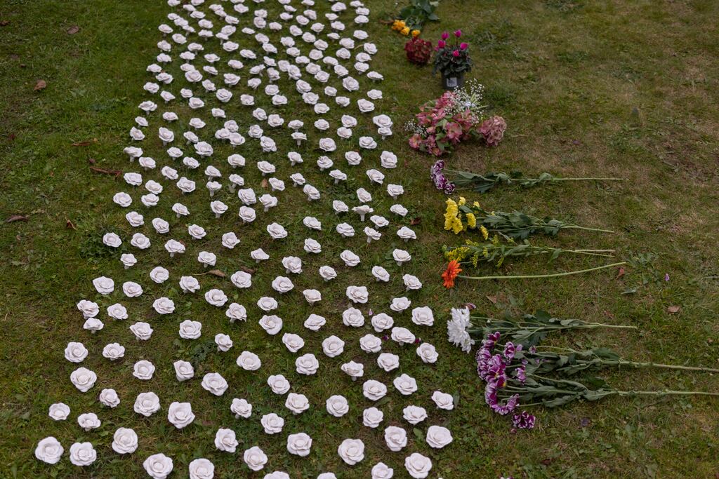 Flowers at a gathering in memory of the hundreds of babies buried at the site of a former mother and baby home in Tuam in October. Photograph: Paulo Nunes dos Santos/The New York Times