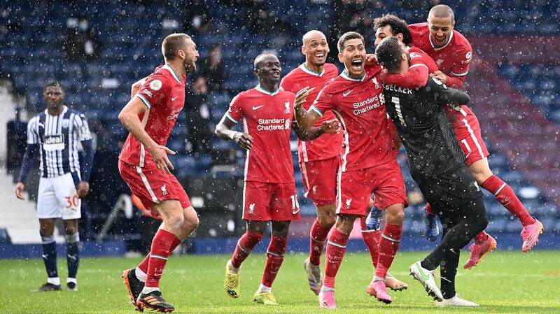 Alisson celebrates with his Liverpool team mates after scoring the winning goal. Photograph: Laurence Griffiths/PA