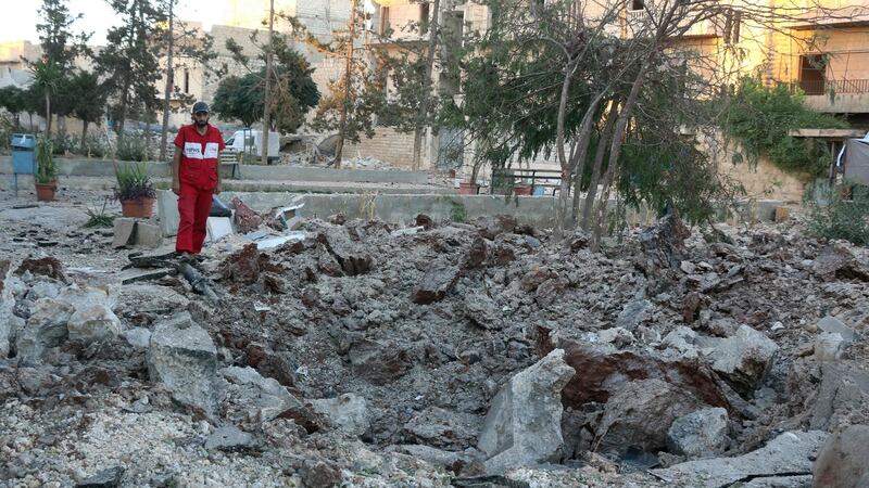 A Syrian medical staff member inspects the damage at the site of a medical facility after it was reportedly hit by Syrian regime barrel bombs on Saturday. Photograph: AFP/Getty Images
