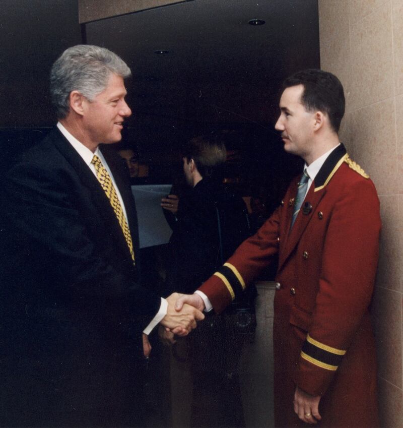 Former US president Bill Clinton with concierge Martin Mulholland at the Europa Hotel in 1998