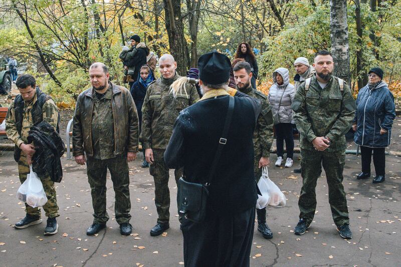 A Russian Orthodox priest performs a blessing for conscripted men in Moscow in October. Photograph: Nanna Heitmann/The New York Times