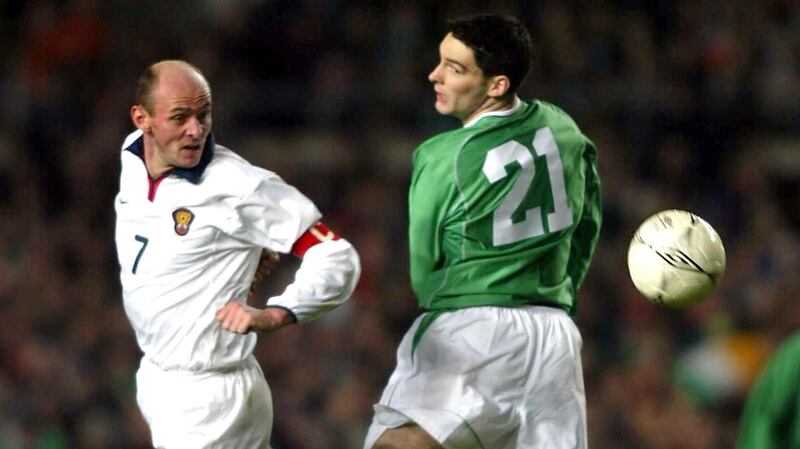 Richie Sadlier challenges Viktor Onopko of Russia for the ball during an international. Photo: Andrew Paton/Inpho
