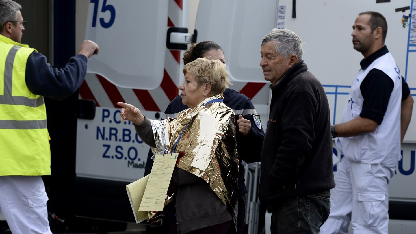 Emergency services personnel escort people away from the site of a collision in Puisseguin, near Libourne, southwestern France. Photograph: AFP
