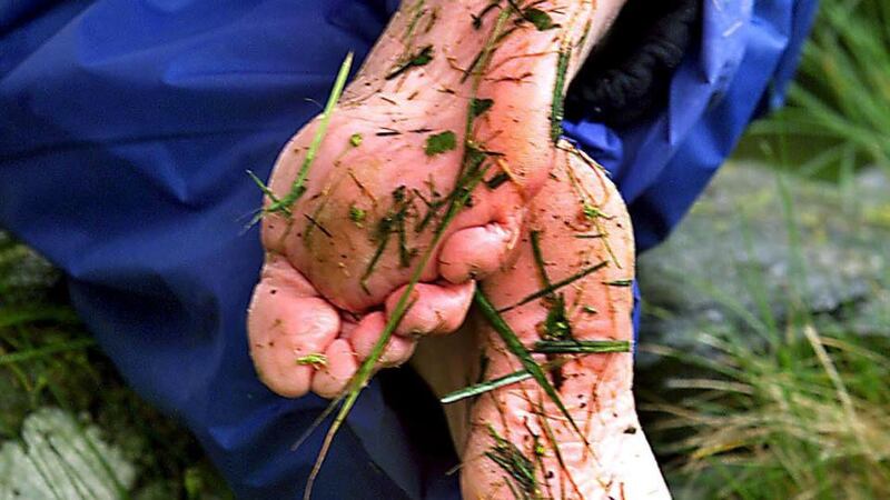 A bare-footed pilgrim in prayer, on the three-day pilgrimage at Lough Derg. Photograph: Eric Luke