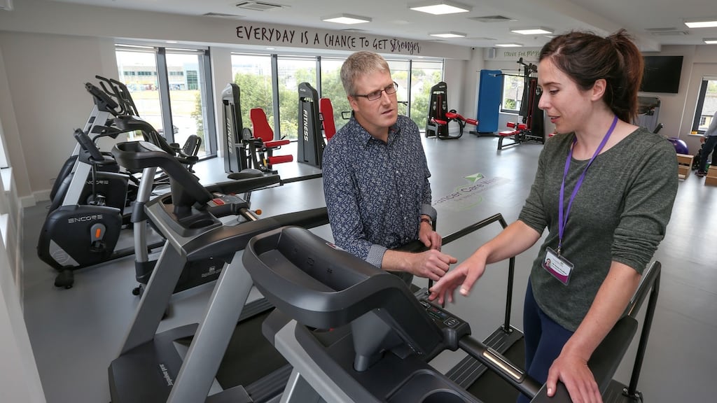 Physiotherapist Emma Houlihan with recovering patient Tom McCarthy in the new gym at Cancer Care West’s support centre in Westside, Galway. Photograph: Joe O’Shaughnessy