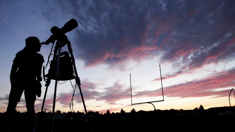A woman watches through a telescope at Madras High School ahead of a solar eclipse in Madras, Oregon, US. Photograph: Jason Redmond/Reuters