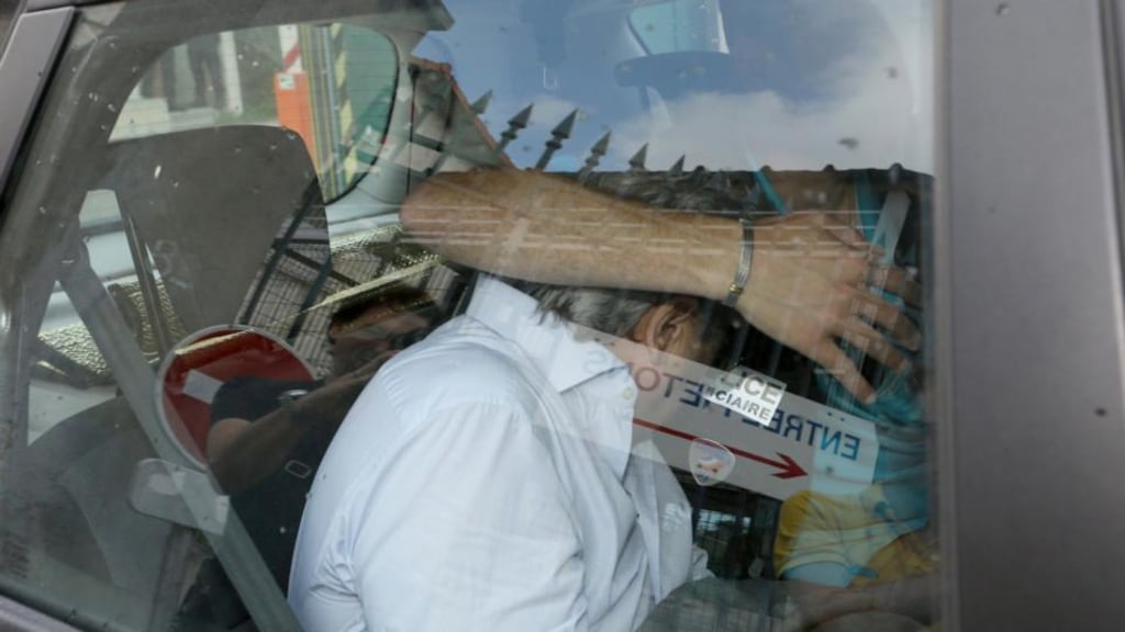 Former Polish honorary consul in Monaco Wojciech Janowski hides his face as he leaves a police station by car in Nice, France today. He is suspected as the mastermind behind the killing of his mother-in-law Helene Pastor, one of Europe’s wealthiest women. Photograph: EPA.