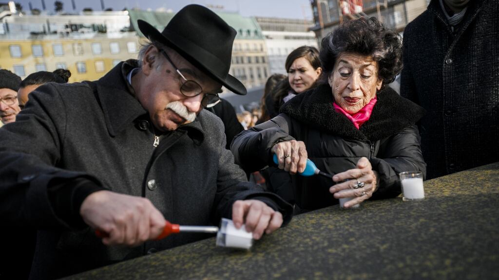 Rabbi Andreas Nachama and publicist Lea Rosh light candles at a commemoration in Berlin of the victims of the Holocaust on the 75th anniversary of the liberation of Auschwitz. Photograph: Carsten Koall/Getty Images
