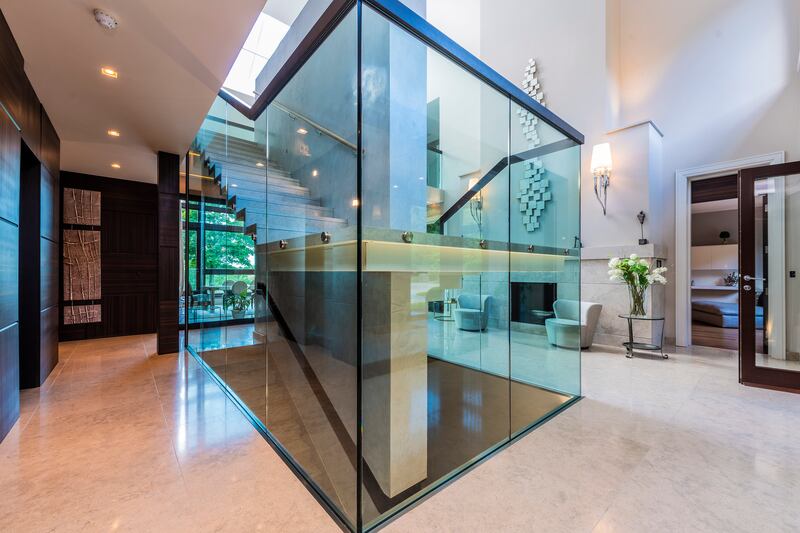 A glass box encases the stairs leading to the basement and up to the first floor and attic