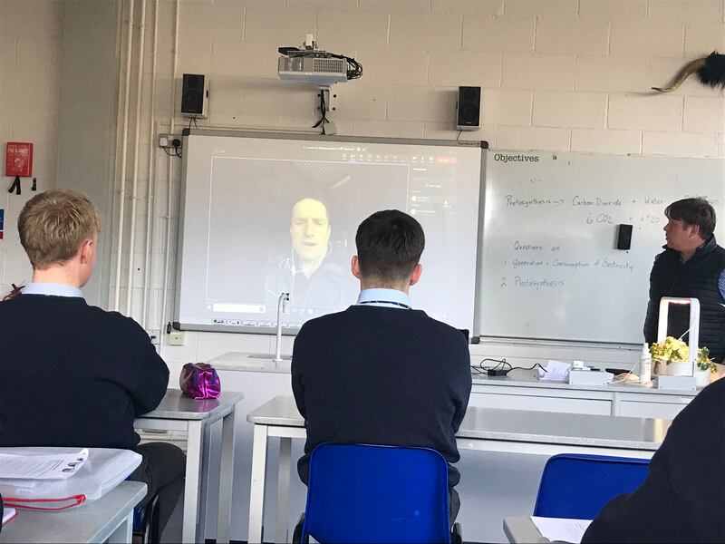 Students at Wesley College watch Noel Clancy's guided tour of his farm.