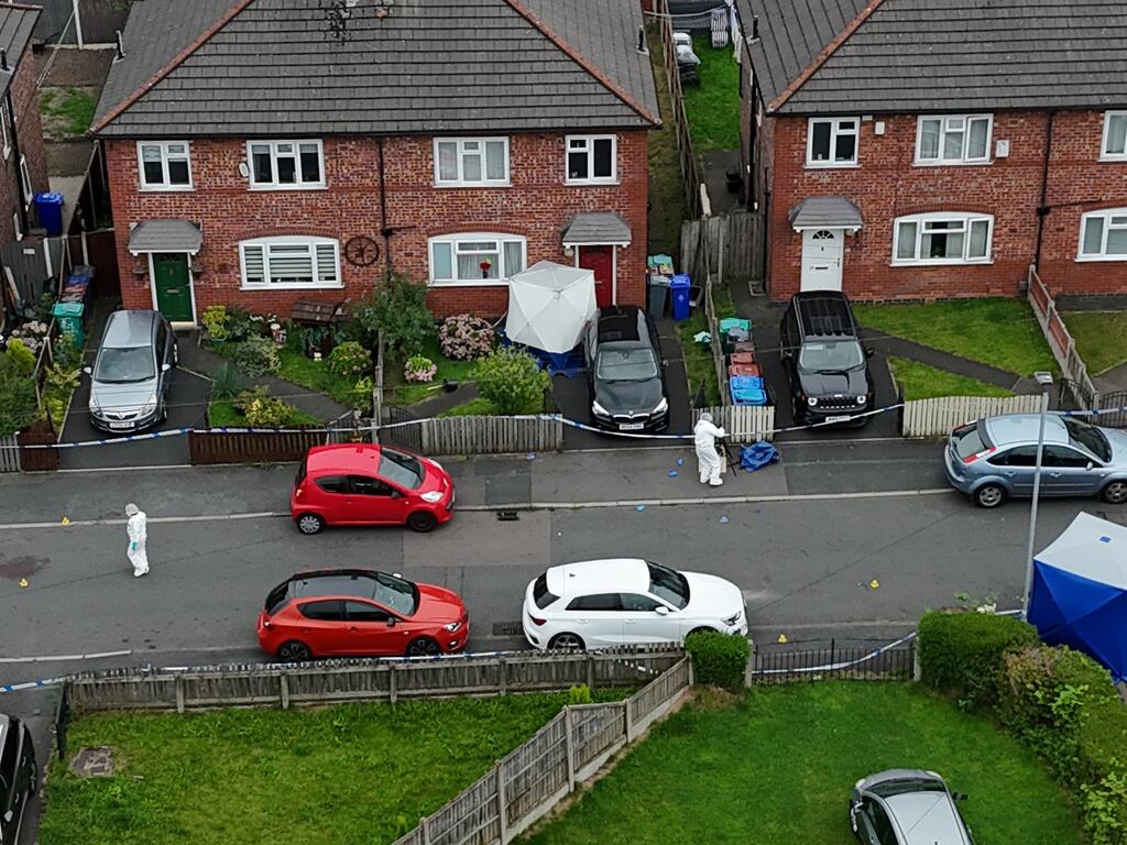 Greater Manchester police officers at the house on Barnard Road in Gorton, Manchester, where the attack happened. Photograph: Peter Byrne/PA Wire