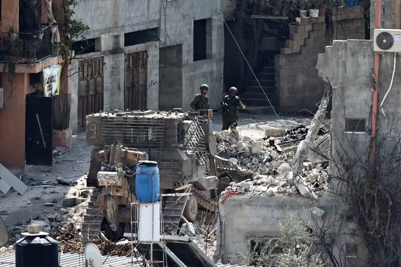 Israeli soldiers look on as a military excavator demolishes a building in the Nur Shams camp for Palestinian refugees, amid an ongoing offensive in the occupied-West Bank, on March 6th, 2025. Photograph: Getty Images