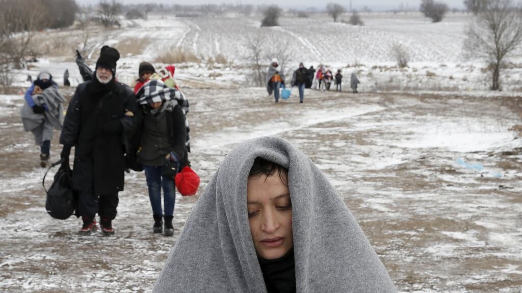 Migrants walk through a frozen field after crossing the border from Macedonia, near the village of Miratovac, Serbia, on Monday. Photograph: Marko Djurica/Reuters