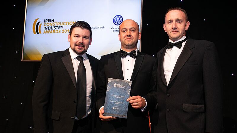 Brendan O'Riordan, CEO, Zutec presents the International Project of the Year award to Richard Carron & Colm Connolly, The Deluxe Group.