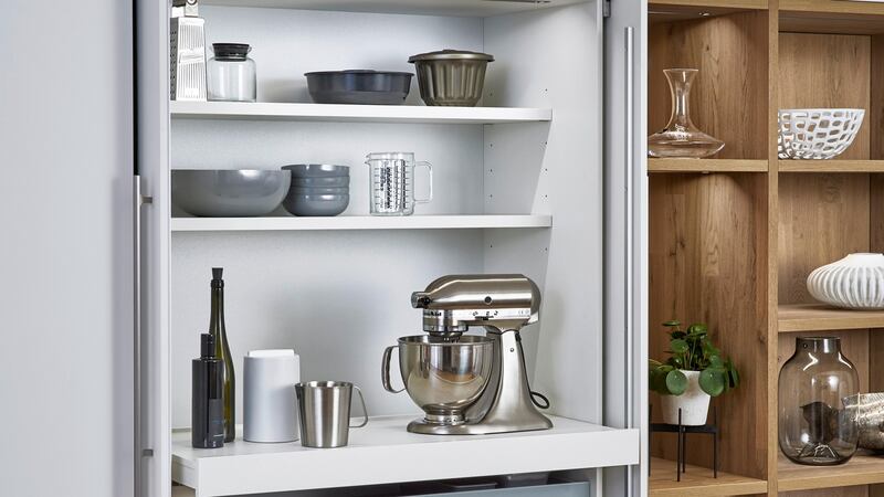 This unit features pocket doors that disappear into the cabinetry, an idea that works especially well in smaller spaces.