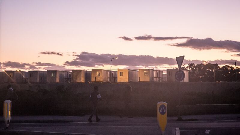 Men walk towards the entrance of the Hal Far centre in Malta. Photograph: Sally Hayden